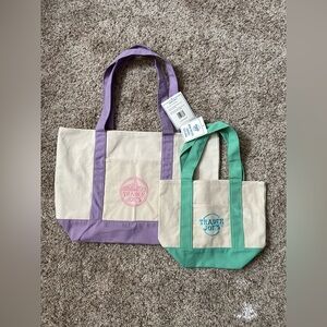 1 large lavender and 1 mini green trader joe’s tote